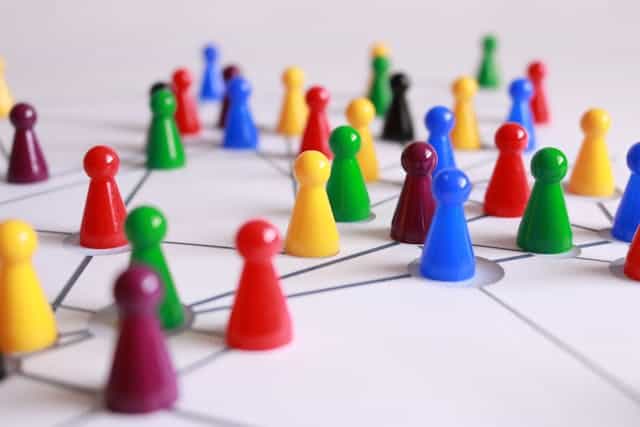 Many plastic cones of different colors on a white surface with connecting lines representing a network for shoestring independent consultants.