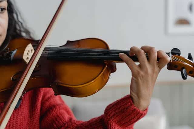 Consultant woman practicing the violin to become an expert.